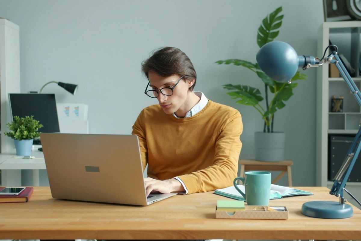 A learner reviewing course information at a laptop
